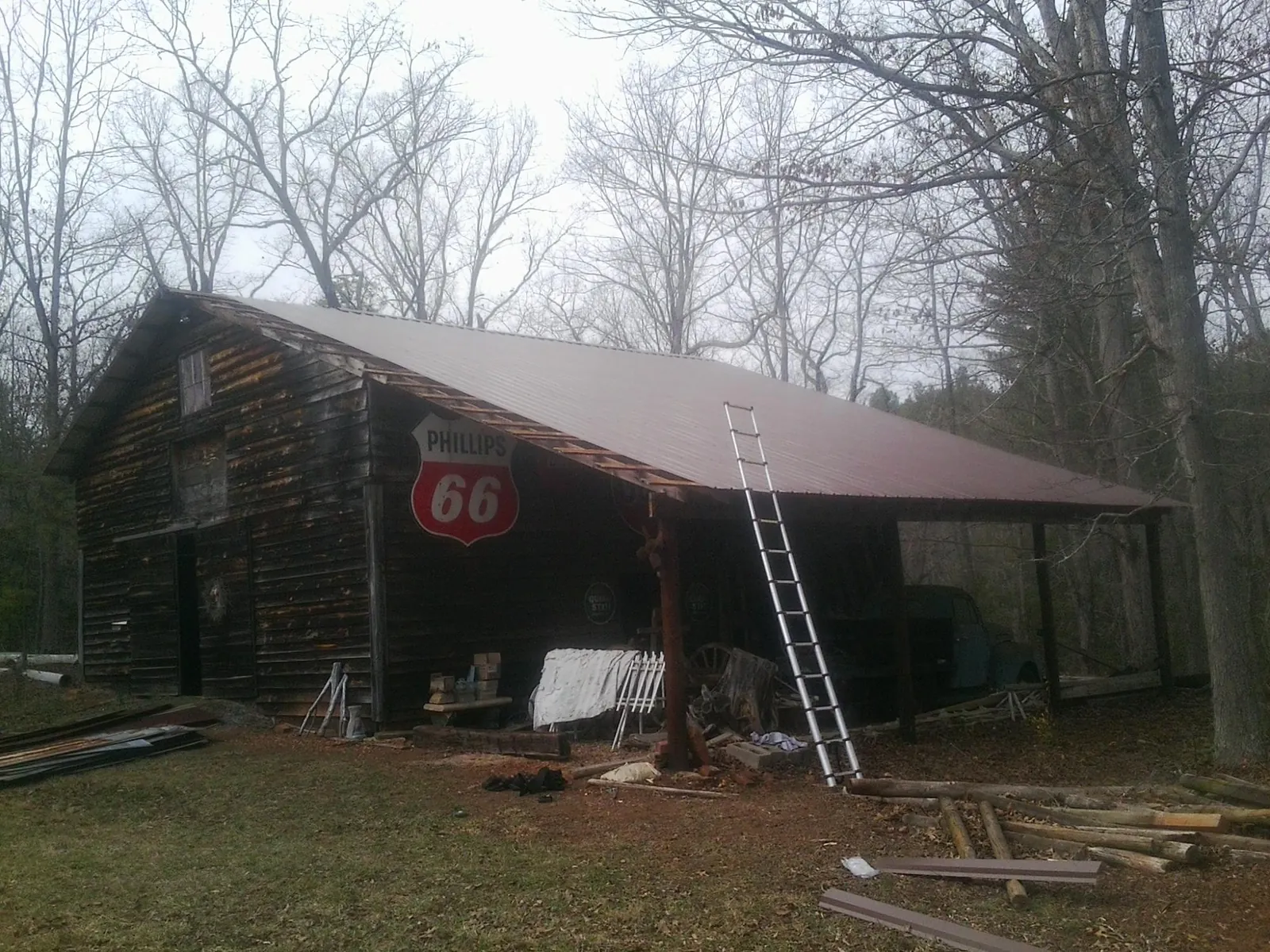 New metal roof on an open sided timber barn with a vintage sign in Stoneboro
